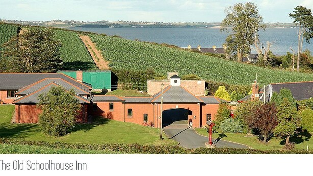 The Old Schoolhouse Inn with a view of the sea and vineyards.