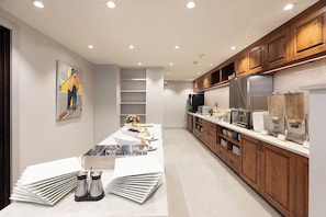 Enjoy cooking in this well-equipped kitchen with a sink, refrigerator, and ample storage.