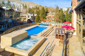Relax by the resort pool surrounded by a wooden deck and take in the scenic views of the surrounding mountains.