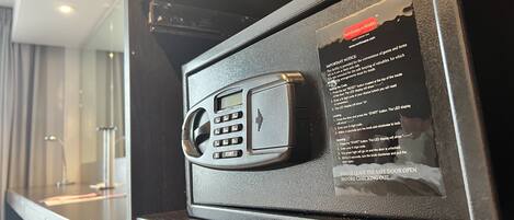 A safe with a keypad and a notice detailing its use.