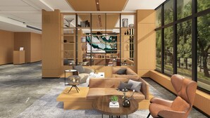 Un interior moderno con un mostrador de recepción de madera, un sofá, una mesa de centro y una estantería.