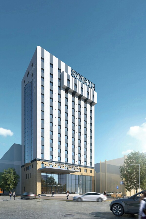 A modern hotel with a prominent 'Starfield' sign, a glass facade, and a parking area with cars. - Fairfield by Marriott Harbin Downtown (Harbin)