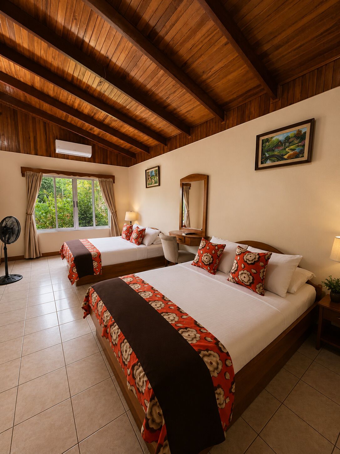 A hotel room with two beds, a fan, a window with curtains, a painting, and a mirror.