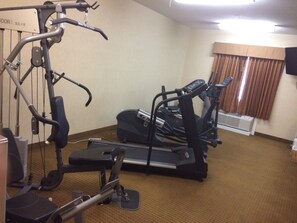 A gym with cardio equipment including treadmills and an elliptical machine.