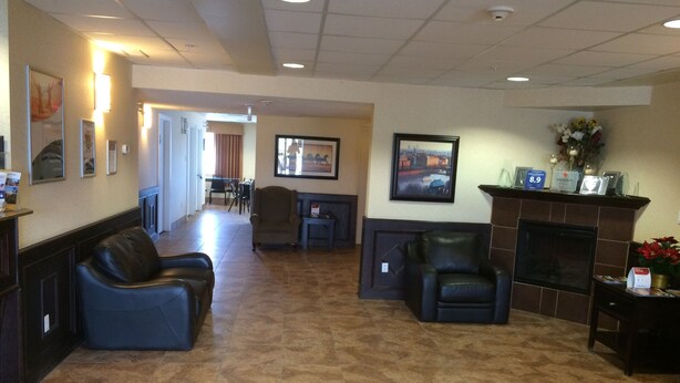 A lobby with a fireplace, seating area, and a reception desk. - Comfort Inn & Suites Edson - Yellowhead Highway (Edson)