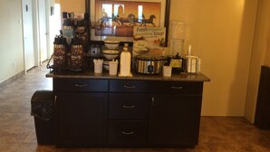A breakfast bar with coffee machines, bowls, and a sign advertising fresh prepared soup. - Comfort Inn & Suites Edson - Yellowhead Highway (Edson)