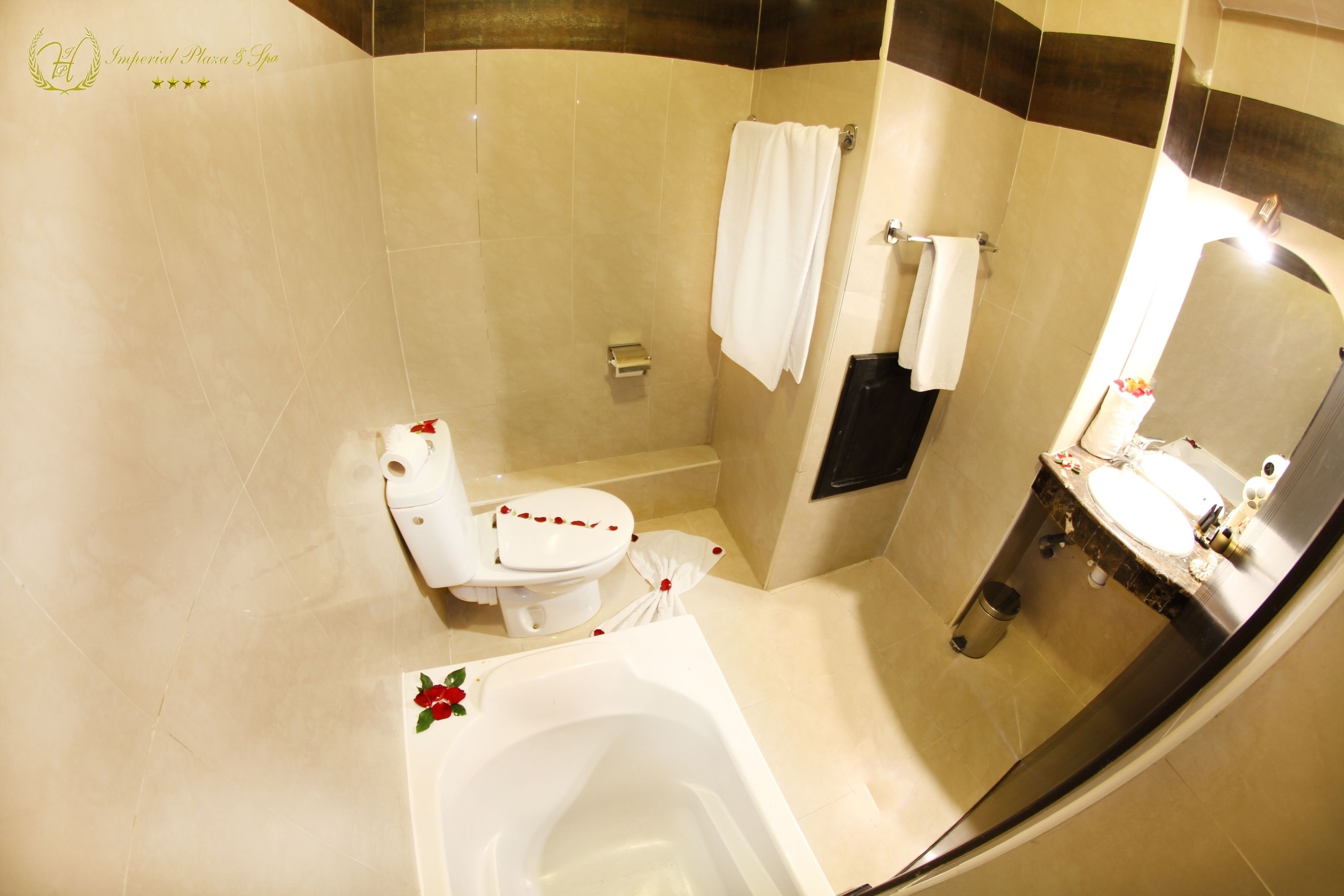 A bathroom with a bathtub, toilet, and sink.