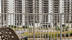 A high-rise hotel with multiple balconies, a view of the beach, and a parking area. - Club Wyndham at Majestic Sun (Miramar Beach)