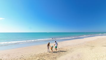 On the beach, white sand, free beach cabanas, sun loungers
