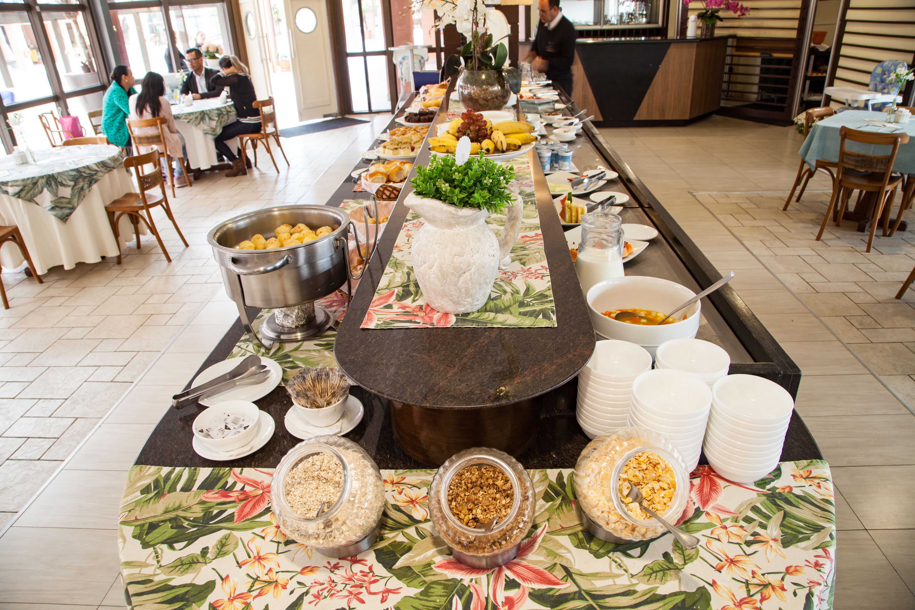 A buffet setup with various food items and serving utensils.