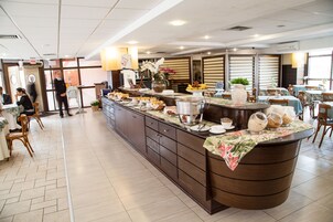 A buffet area with a variety of food items, a reception desk, and seating arrangements.