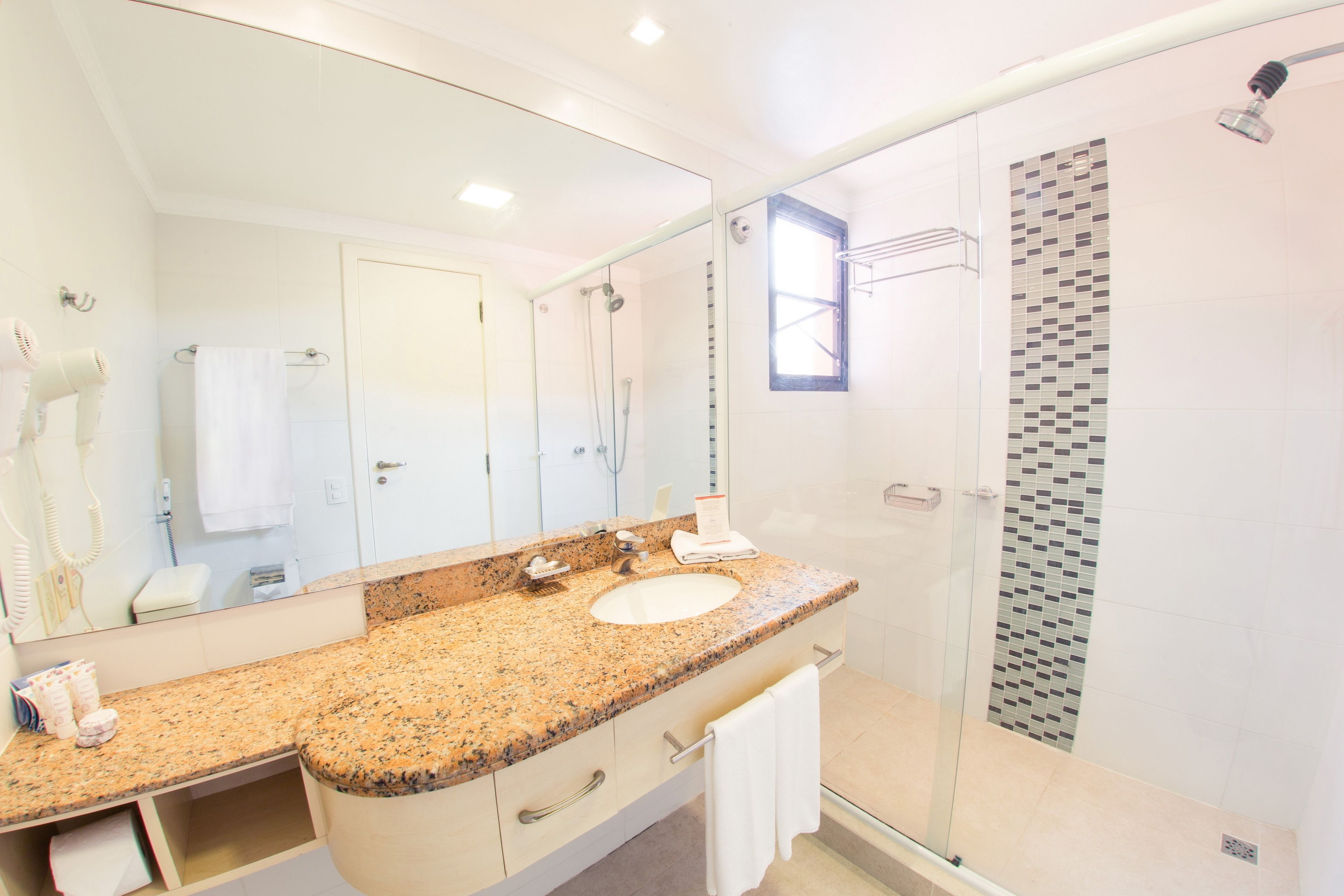 deluxe suite | bathroom | hair dryer, towels