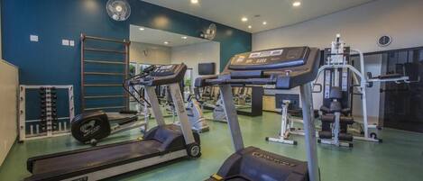 A gym with treadmills, ellipticals, and weight machines.