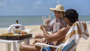 On the beach, white sand, sun-loungers, beach umbrellas