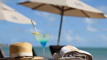 On the beach, white sand, sun-loungers, beach umbrellas