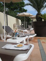 Seasonal outdoor pool, open 9:00 AM to 10:00 PM, sun loungers