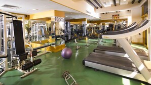 A gym with various exercise equipment, including treadmills, weight machines, and free weights. - Baisan International Hotel Bahrain (Manama)