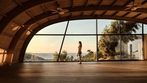 A spacious room with a large arched ceiling, a view of the sea, and a person standing in the center. - Seaside A Lifestyle Resort All Inclusive (Malevizi)