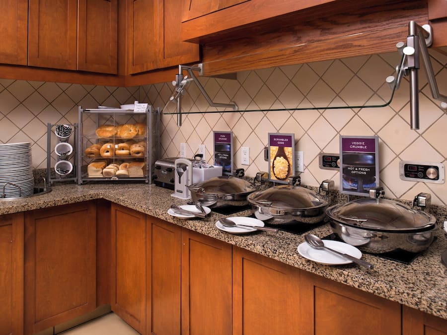 A breakfast buffet with various food items and a coffee machine.