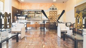 Un espace bar moderne avec un sol en marbre, un comptoir et des sièges confortables.