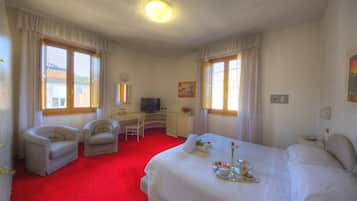 Relax in a serene space with a large bed, desk, and TV, plus a convenient breakfast area.