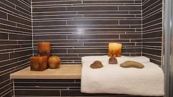Relax in this serene space with a bathtub, candles, and soothing stones.