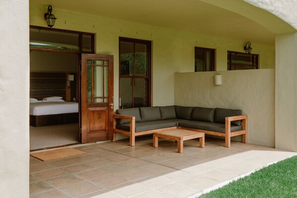 A room with a bed, a sofa, and a coffee table.