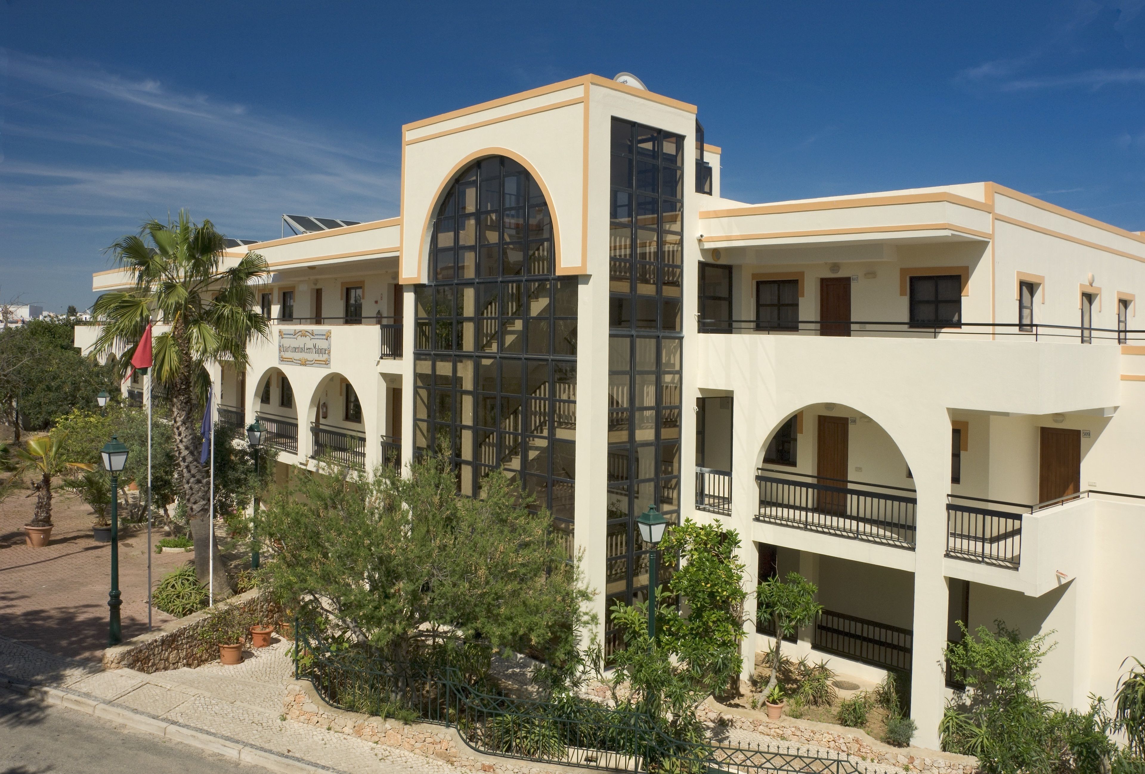 A multi-story hotel with a central atrium, balconies, and a mix of arched and rectangular windows.