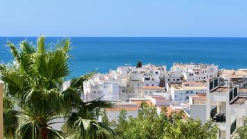 A coastal town with white buildings and a clear blue sky.