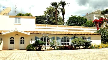 A building with a reception area, satellite dishes, and a tiled roof.