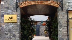 The entrance to The Court Yard Hotel with a stone facade and a wrought iron canopy. - The Court Yard Hotel (Leixlip)