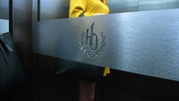 A metallic surface with a monogrammed emblem.