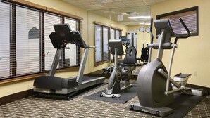 A gym with treadmills, an elliptical, and a stationary bike.