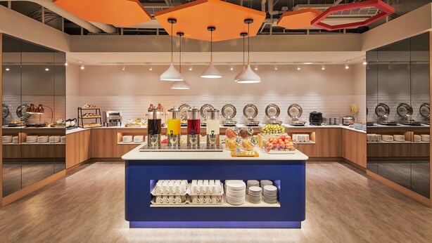 A modern breakfast buffet with a central island, various food options, and a clean, contemporary design. - Holiday Inn Express Taichung Park by IHG (Taichung)