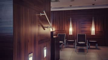 A modern waiting area with wooden paneling, a reception desk, and two chairs.