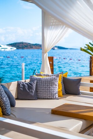 On the beach, sun loungers, beach umbrellas, beach towels