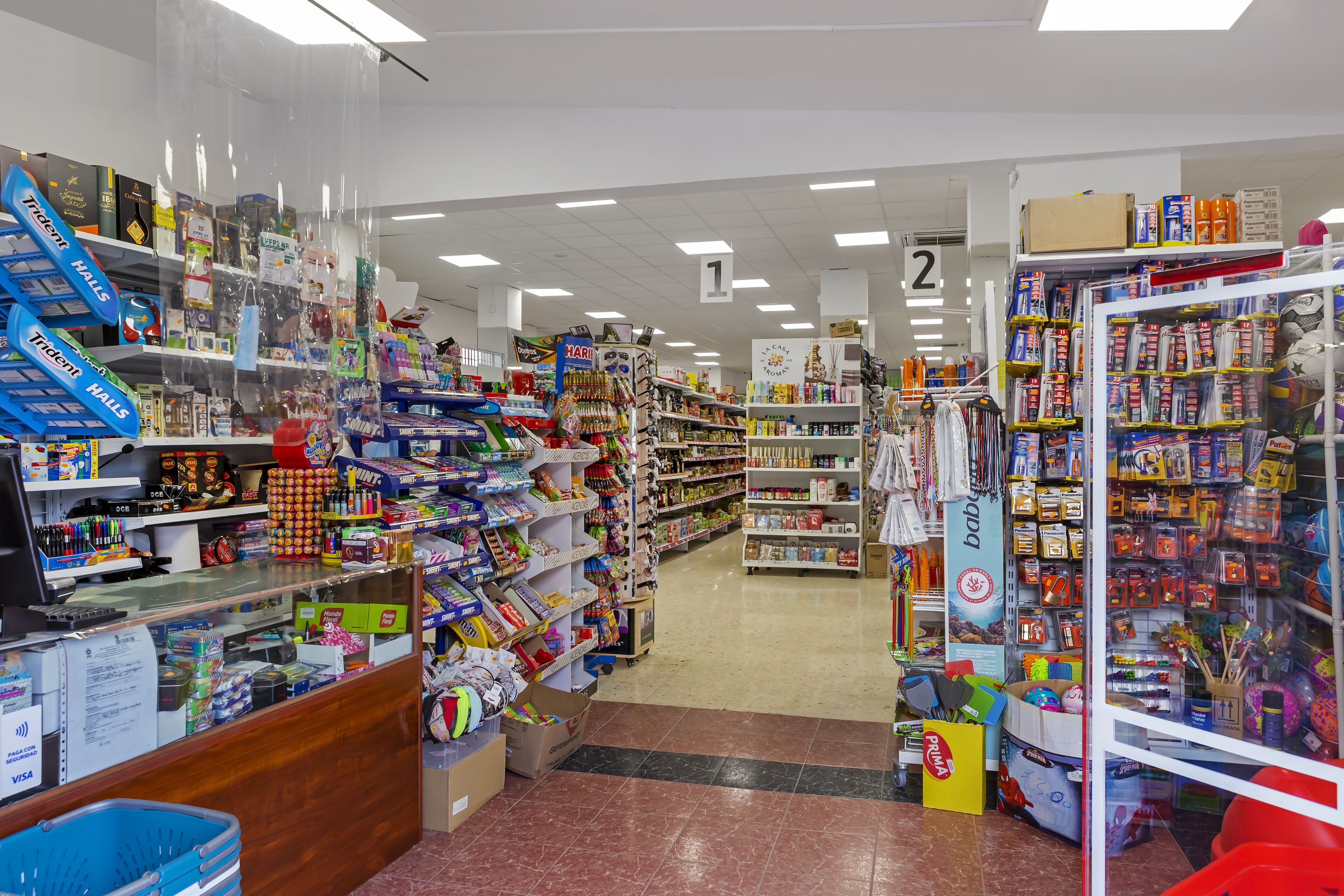 A store with shelves stocked with toys and games, a checkout counter, and a section labeled 'baby'.
