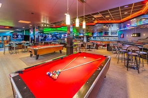A pool table with balls, a bar area, and seating. - Quality Inn & Suites (High Level)