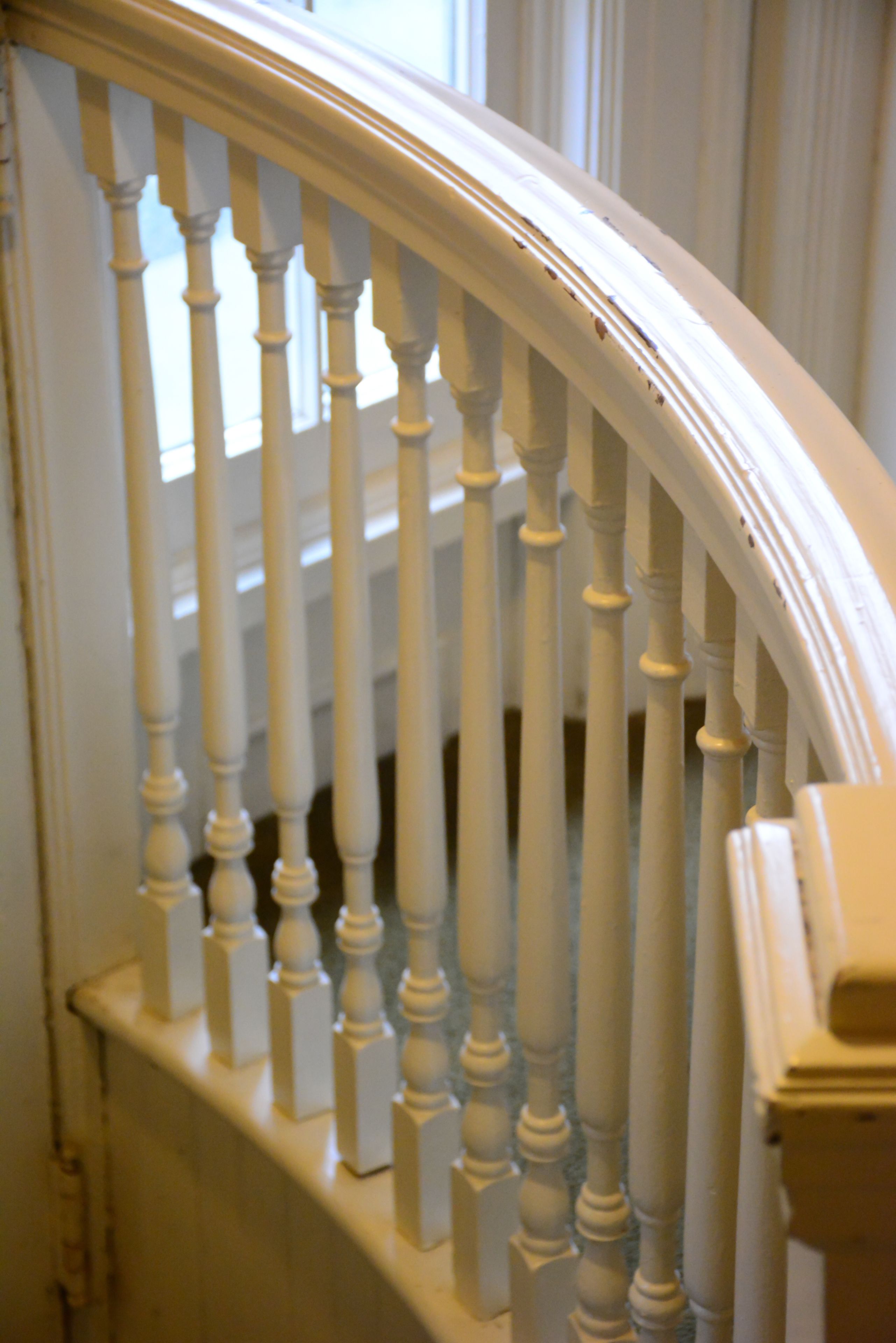 A white wooden staircase with balusters.