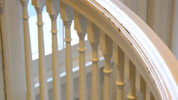 A white wooden staircase with balusters.