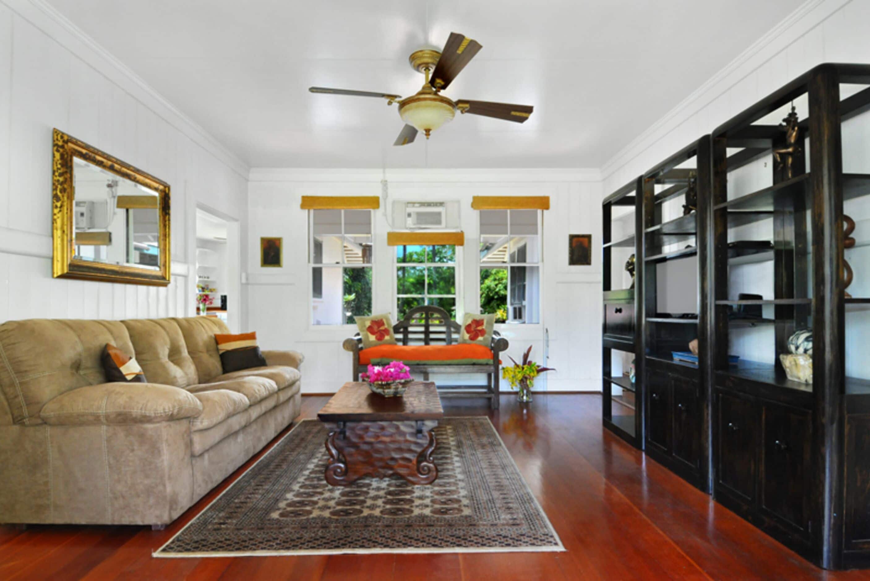 A living room with a sofa, coffee table, and a bookshelf.