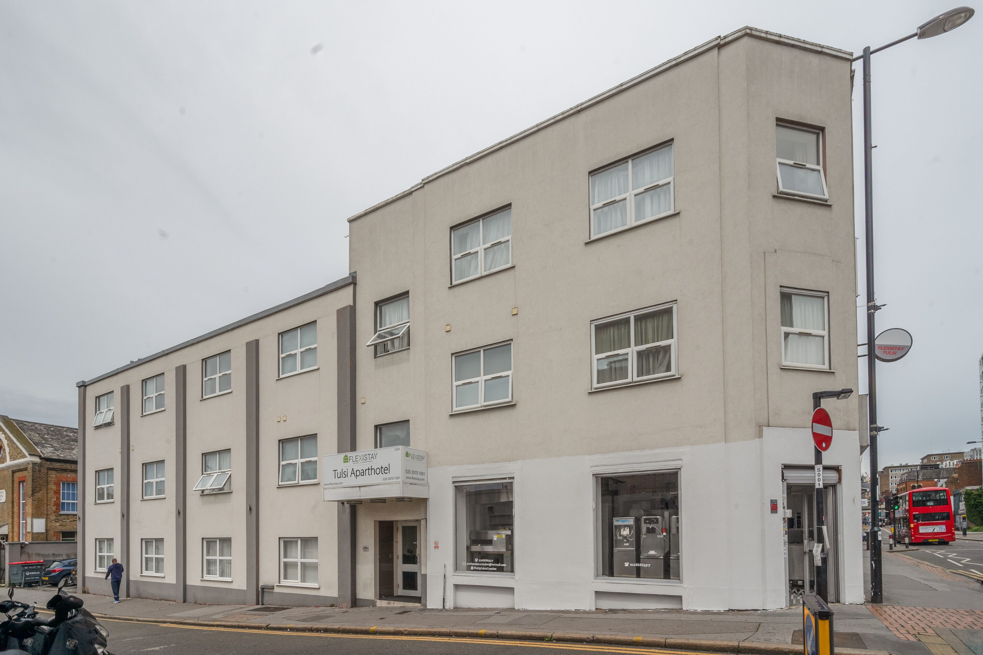 A multi-story building with a sign for 'Tulsiparhotel'.