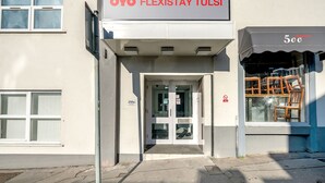 A building entrance with a sign reading "OYO FLEXISTAY TULSI" and a window displaying furniture. - Flexistay Tulsi Aparthotel (Croydon)