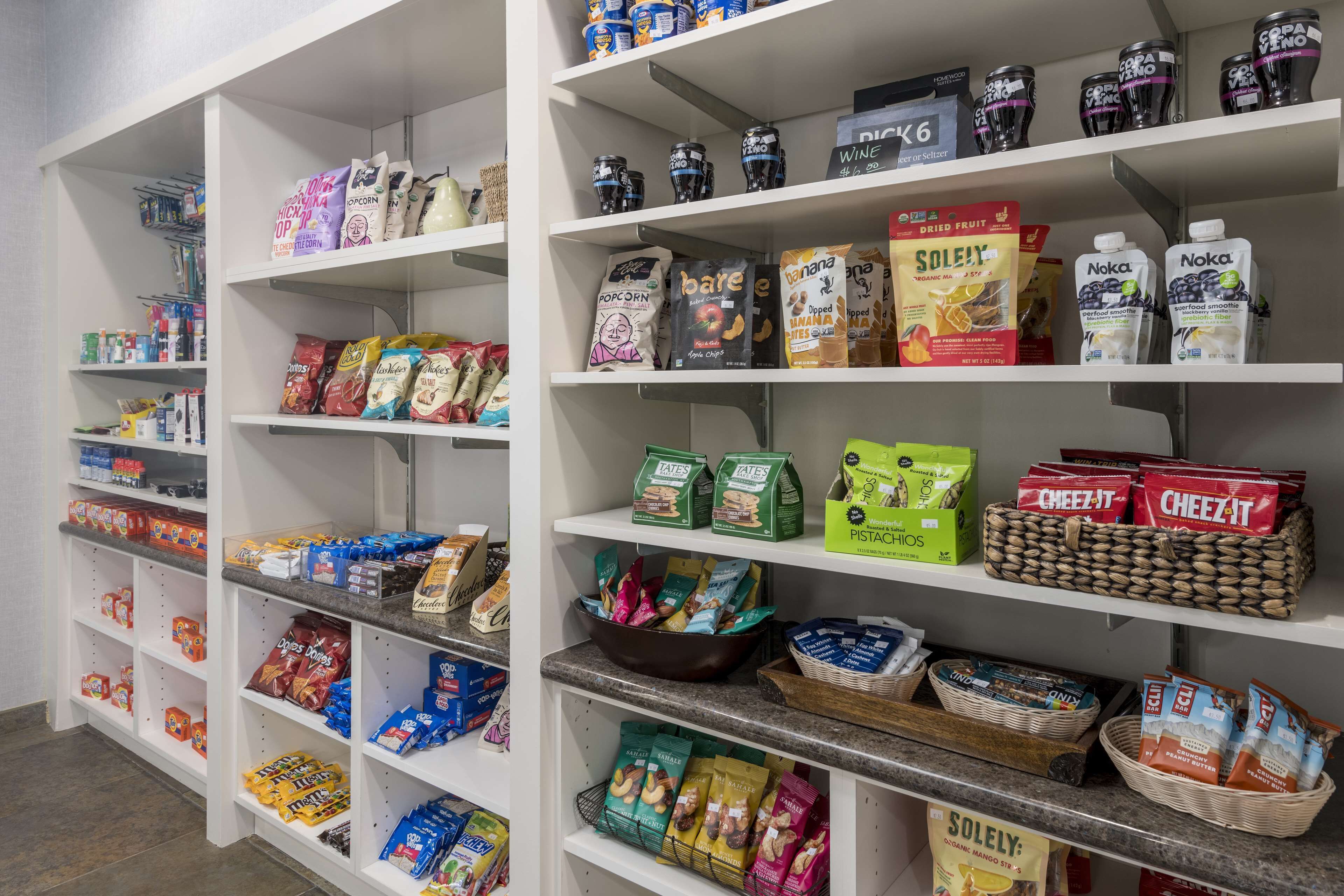 A well-organized pantry with various food items and beverages.