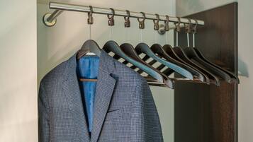 A clothing rack with various garments hanging.