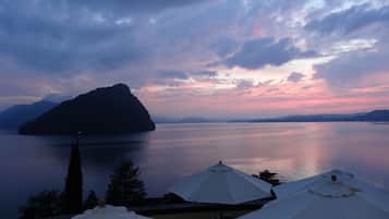 A lakeside view with a large island and a row of white umbrellas.