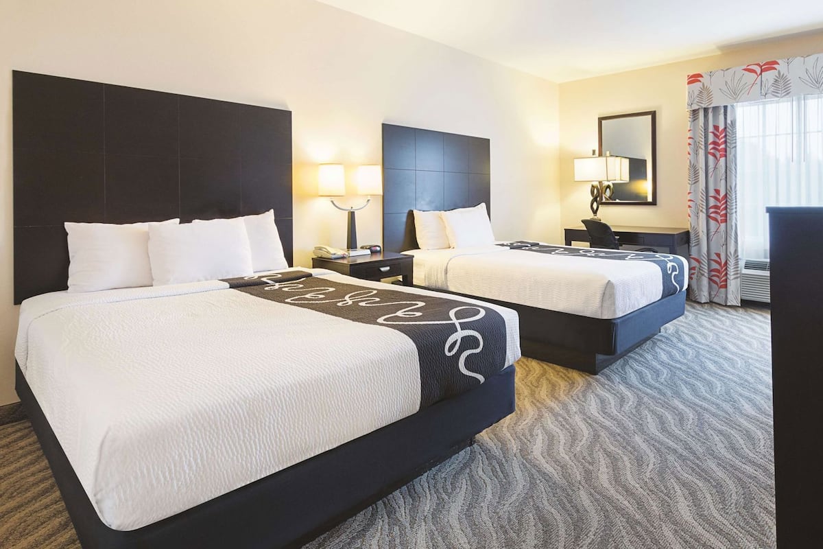 Premium bedding, desk, laptop workspace, blackout drapes