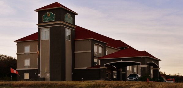 A hotel with a prominent tower and a red roof.