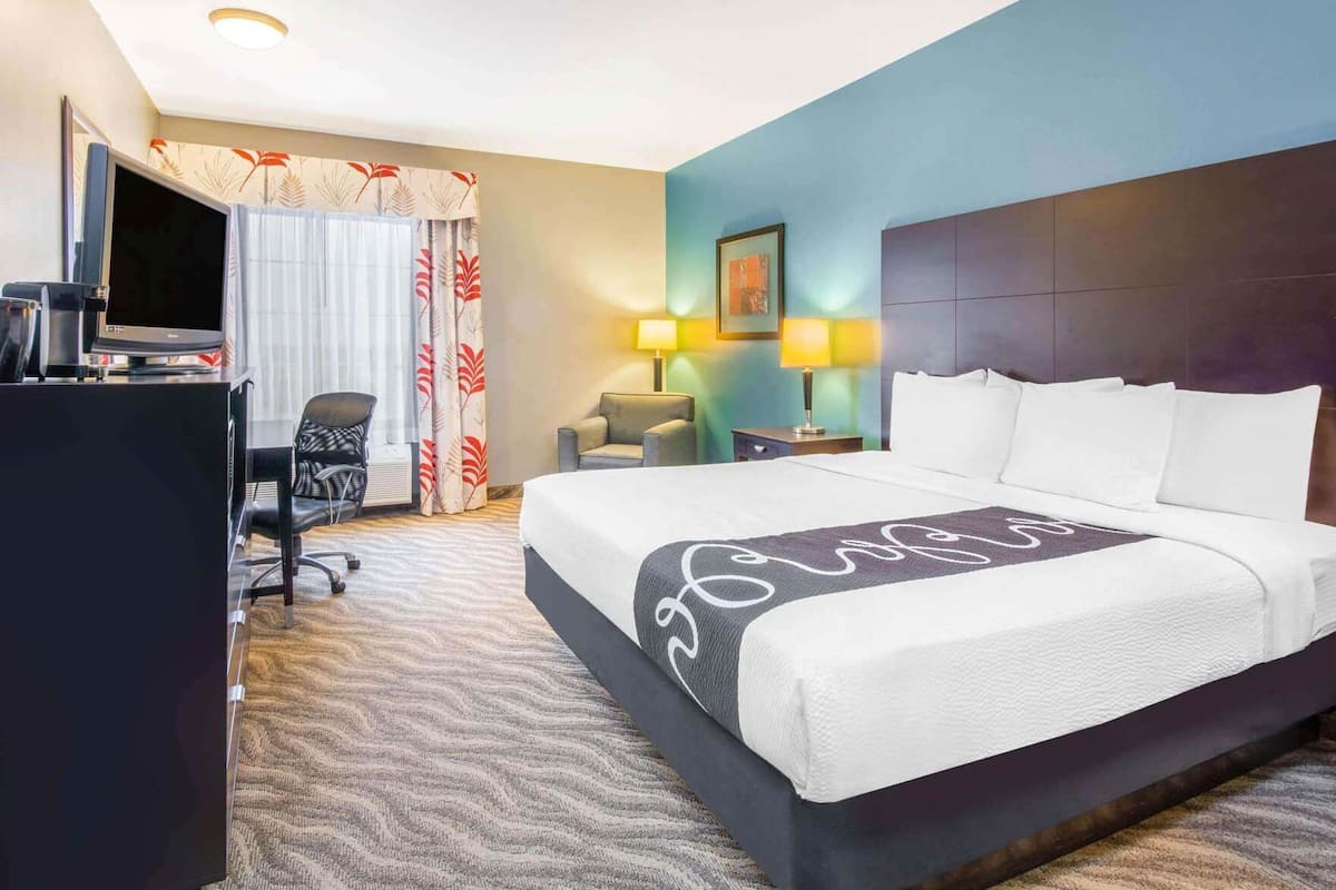 Premium bedding, desk, laptop workspace, blackout drapes