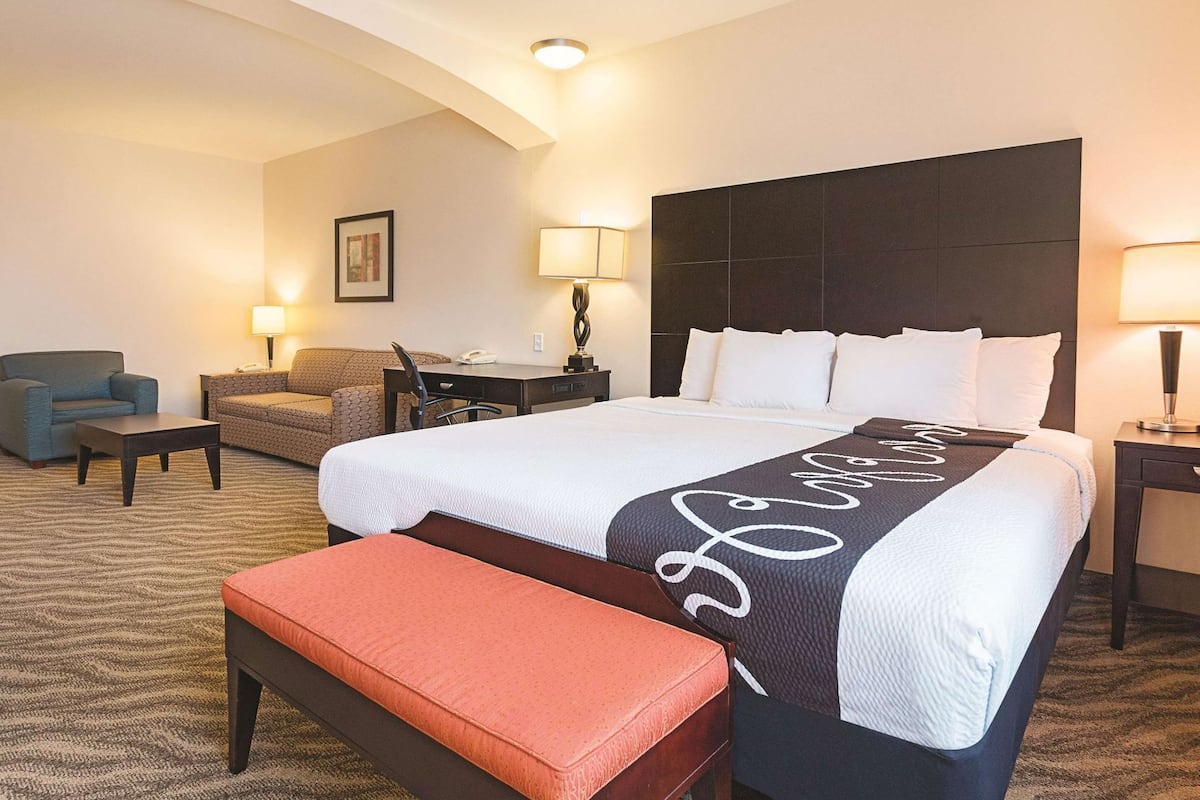 Premium bedding, desk, laptop workspace, blackout drapes